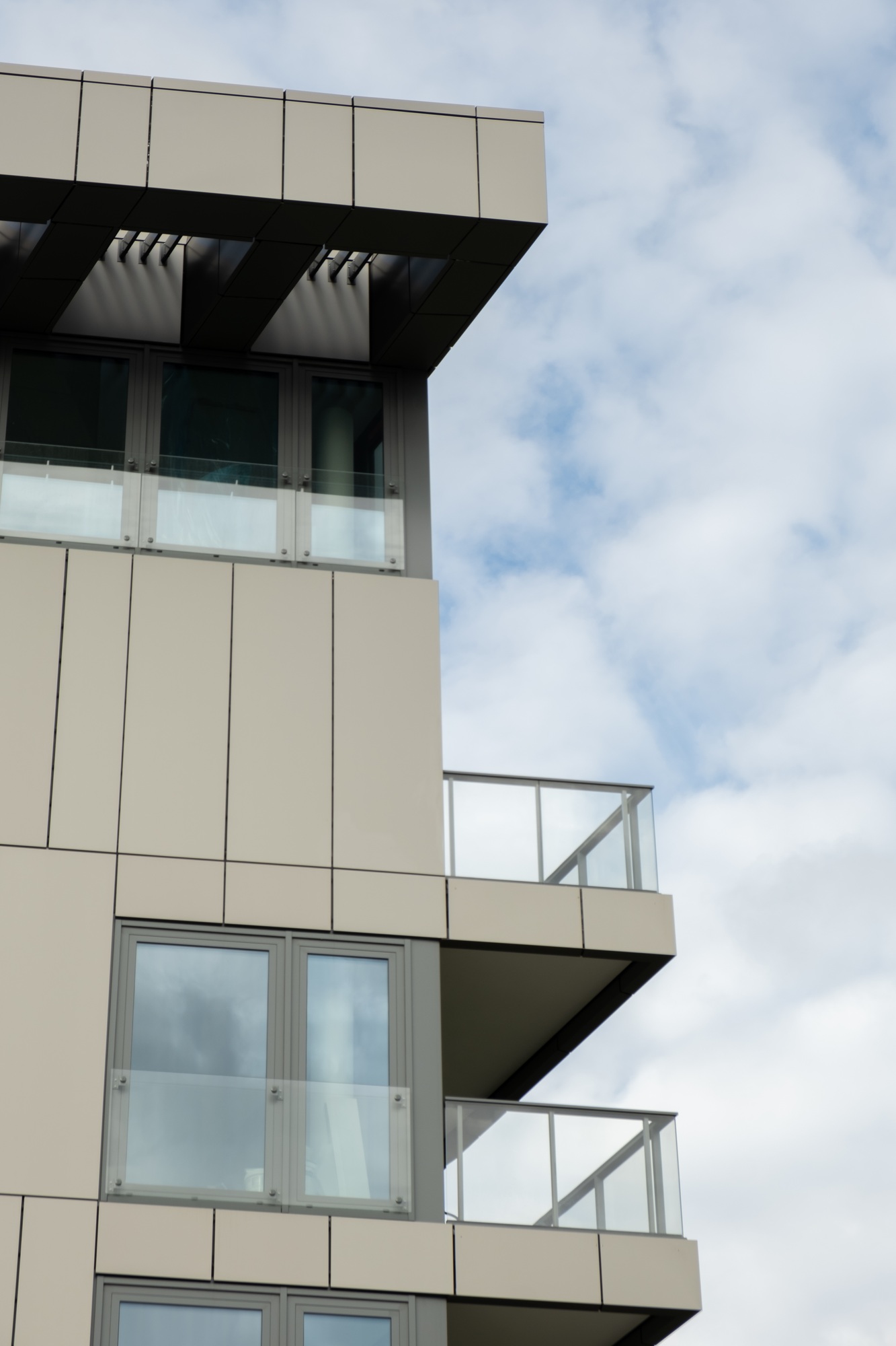 Modern office building exterior with glass facade on clear sky background. Transparent glass wall of